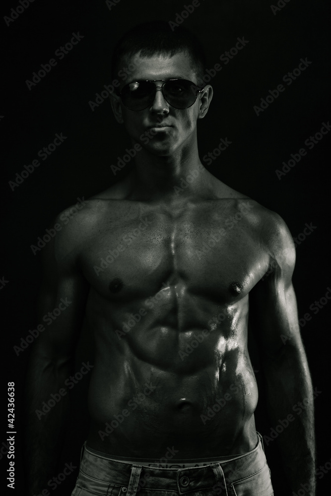 Muscular young man. Bw