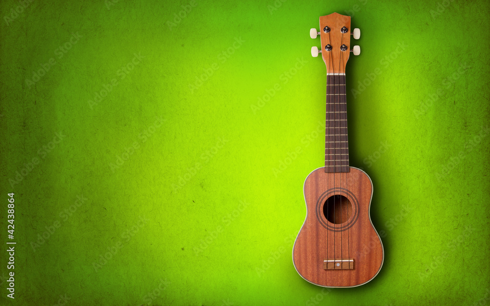 Obraz premium Ukulele on green background