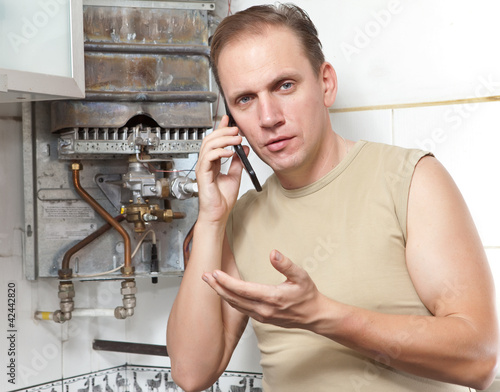 man calls by phone to cause the repairman of gas water heaters