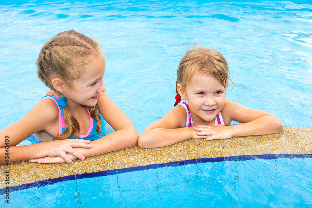 two little girls playing in the pool two little girls playing in the pool