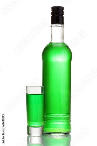 bottle and glass of absinthe isolated on white