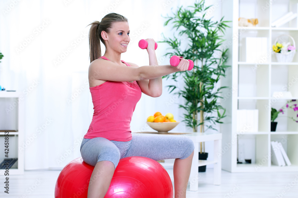 Woman in sportswear, doing fitness exercise with dumbbell Woman in sportswear, doing fitness exercise with dumbbell