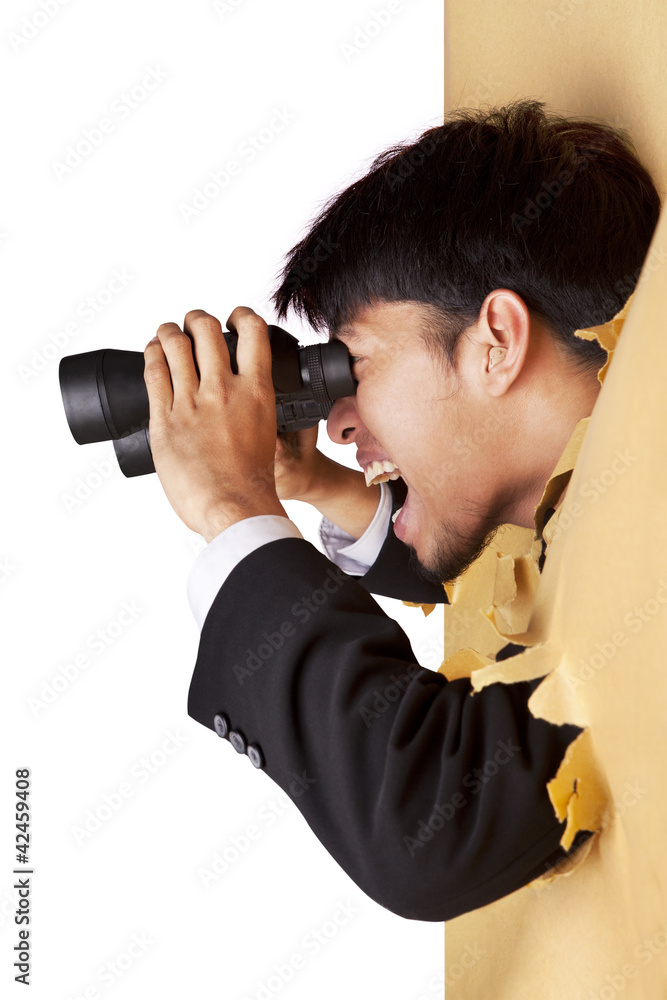 Shocked businessman looking with binoculars Shocked businessman looking with binoculars