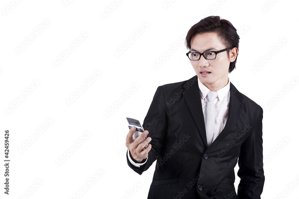Shocked businessman reading a message Shocked businessman reading a message