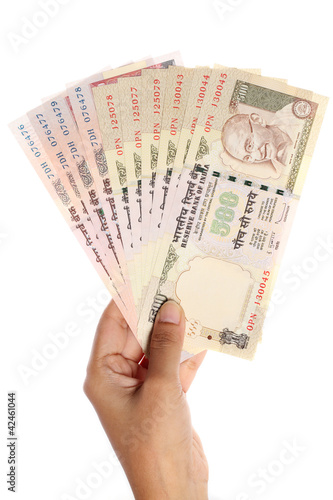 Hand holding Indian rupee notes on white background