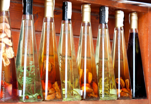 Fototapeta colorful liqueur and vinegar bottles on a market in croatia.
