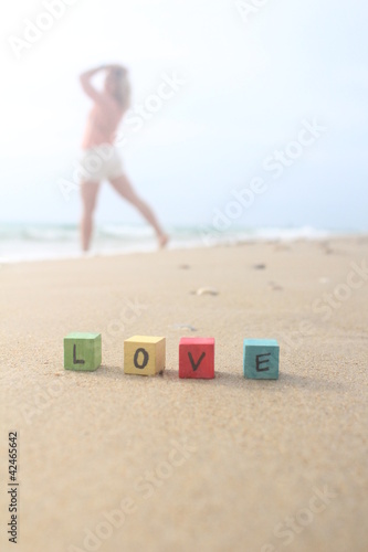 Foto LOVE - written on wood cubes at the beach