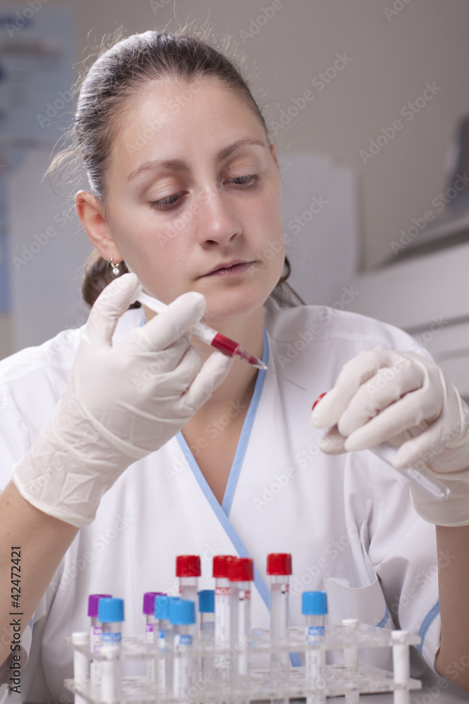 Injecting blood in test tube Injecting blood in test tube