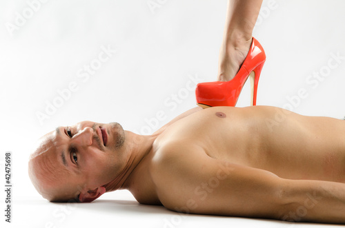 Naked man being stepped on