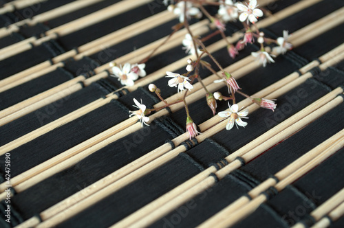 flowers on black bamboo mat