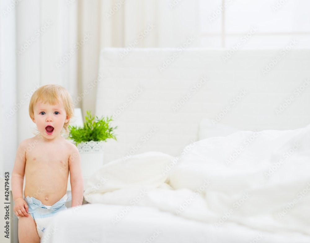Portrait of surprised baby in bedroom Portrait of surprised baby in bedroom