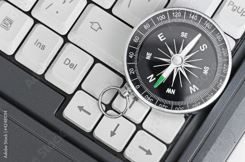 Computer keyboard and retro compass, business decision