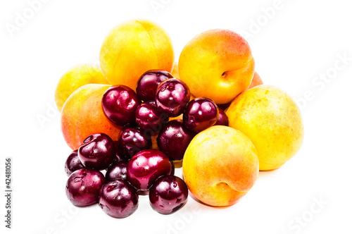 Fruits are ripe apricot and red cherries