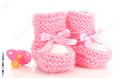 pink baby boots and pacifier isolated on white