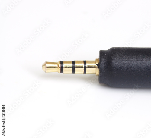 Mini Jack Plug with roll of wire isolated on white background