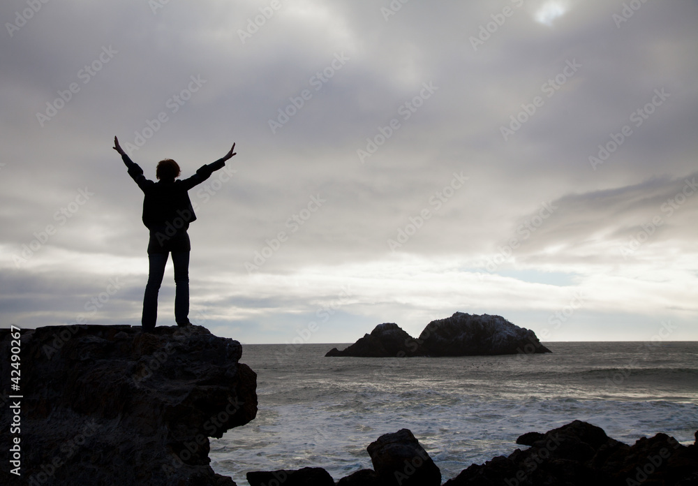 Woman staying with raised hands