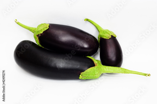 three aubergine on white background