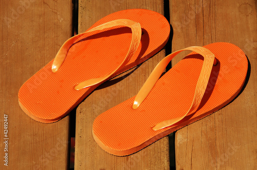 orange flip-flop on wood background