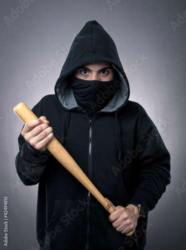 Young hooligan with baseball bat