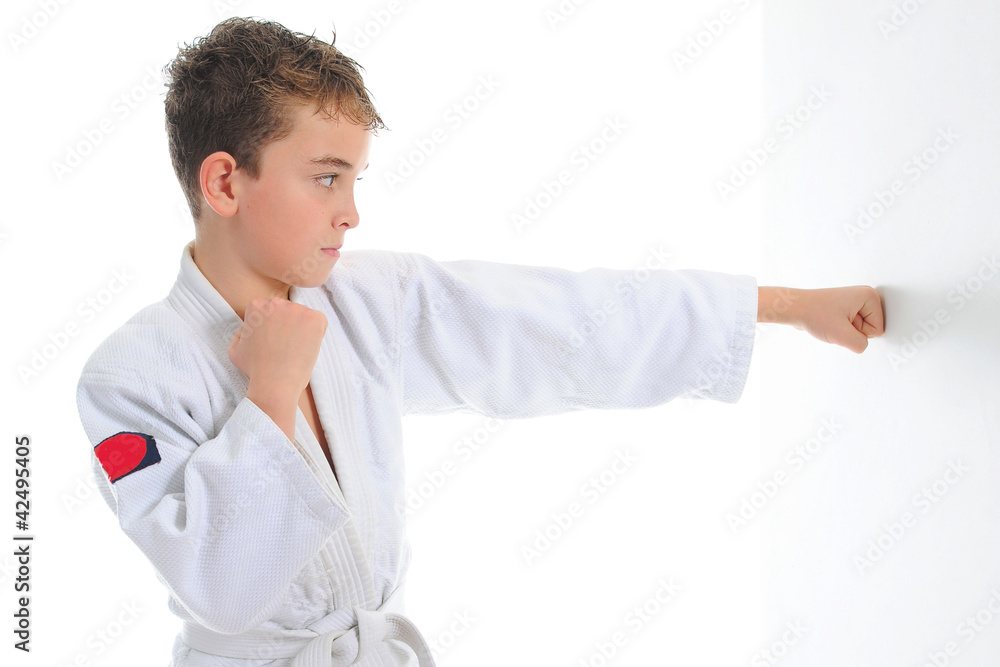 Young boy training karate. Young boy training karate.