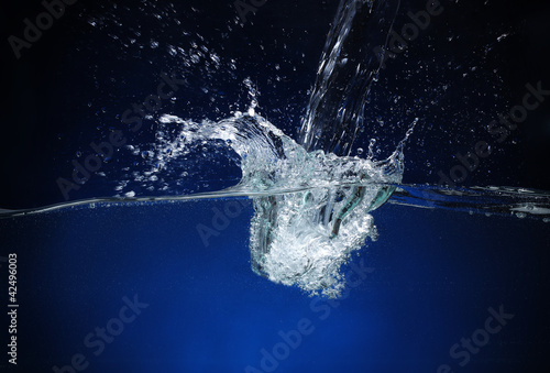 Pouring water. Splash image on a blue background