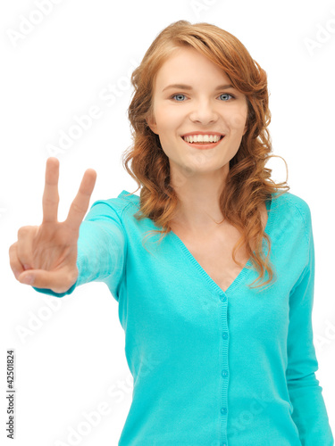 teenage girl showing victory sign © Syda Productions
