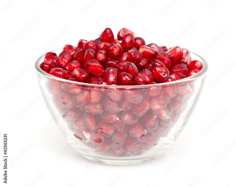 pomegranate in bowl isolated on white pomegranate in bowl isolated on white