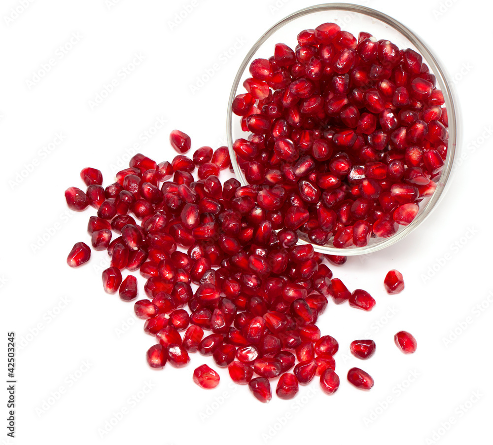 pomegranate in bowl isolated on white pomegranate in bowl isolated on white