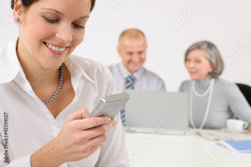 Young executive woman use phone during meeting