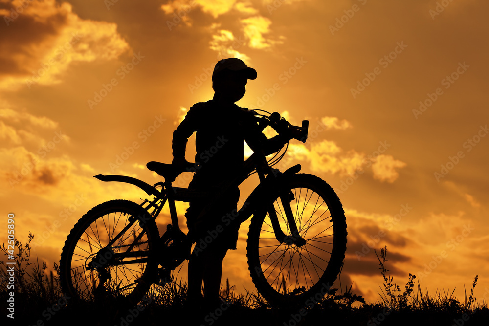 cyclist silhouette on a orange sky cyclist silhouette on a orange sky