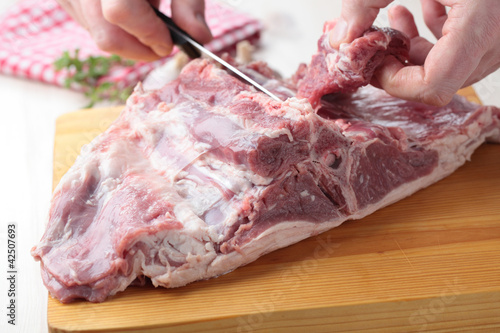 Chopping a saddle of lamb