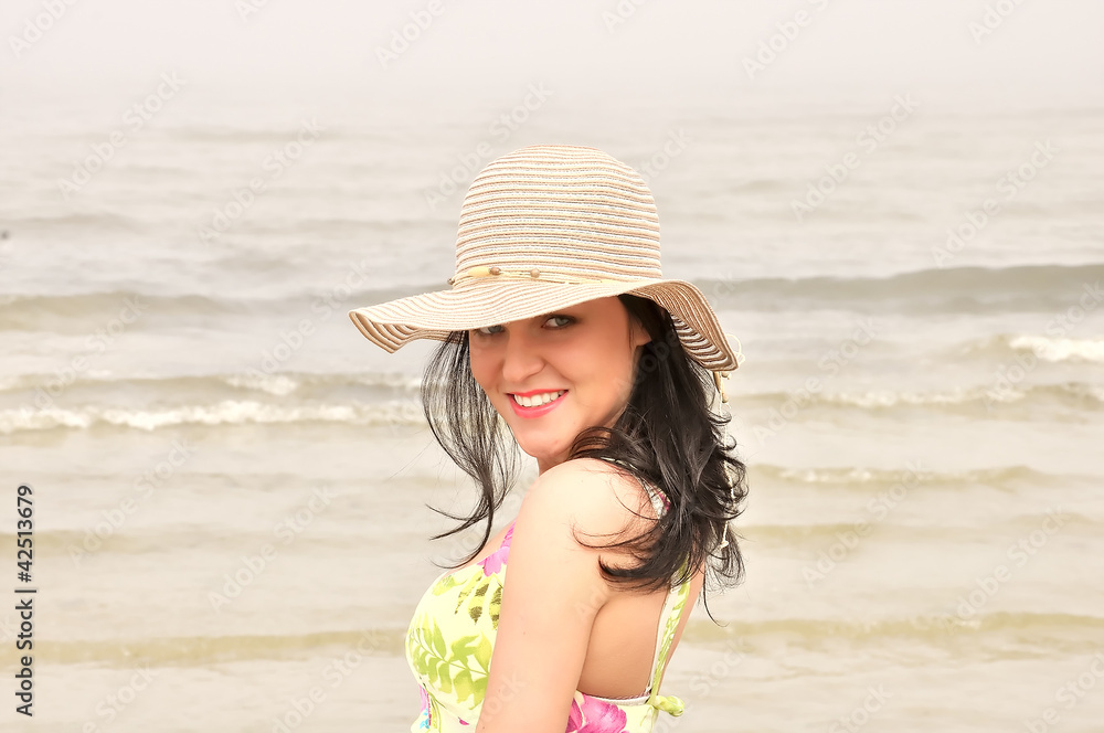Smiling woman in dress and summer hat