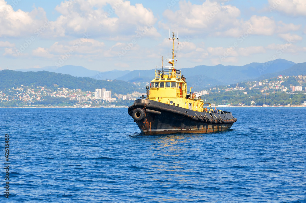Fototapeta premium Yellow sea tow on anchor parking on spot-check of Sochi