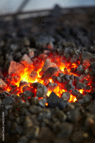 Old-fashioned blacksmith furnace with burning coals