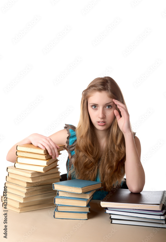The girl with pile of books and writing-books on a white The girl with pile of books and writing-books on a white