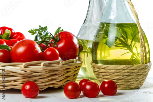 Close-up of cherry tomatoes and a bottle of olive oil