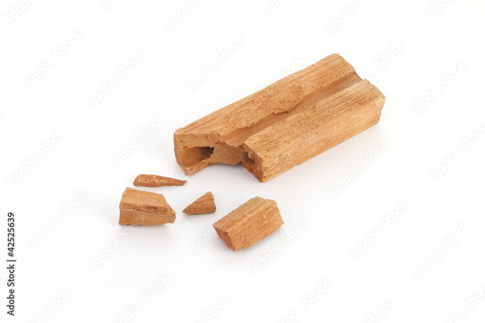 Piece of break brick on white floor. Piece of break brick on white floor.