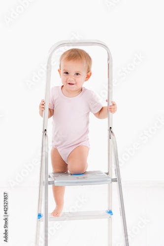 Cute baby climbing on ladder © nyul