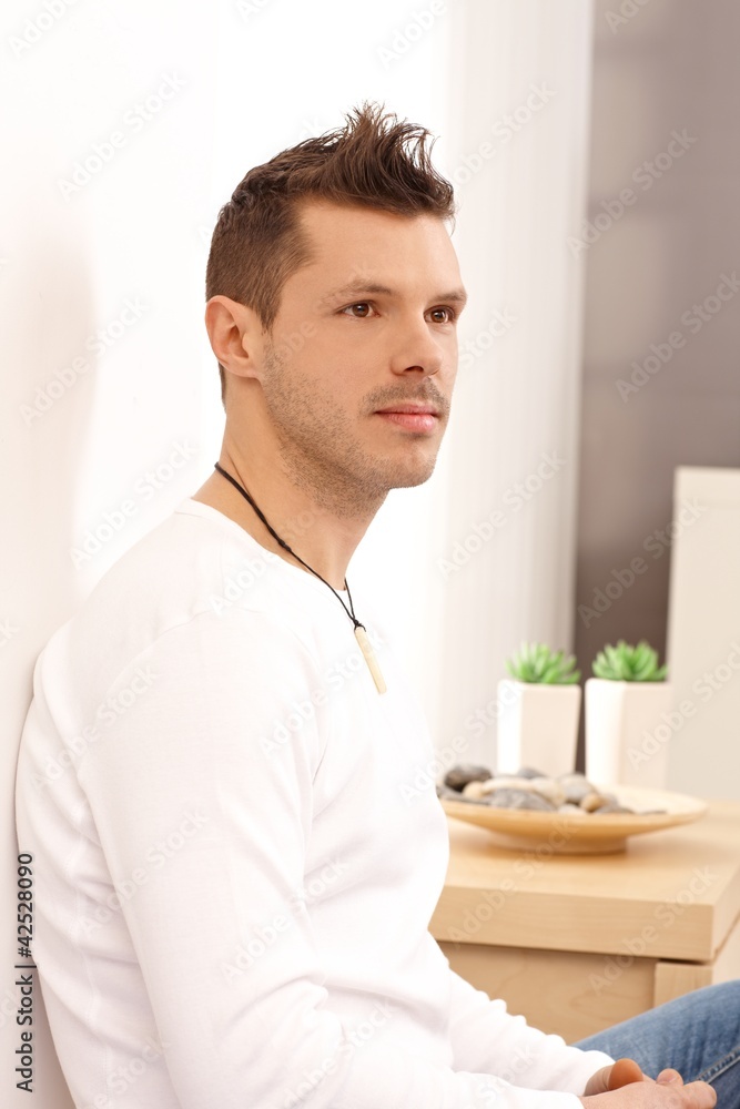 Young man daydreaming at home Young man daydreaming at home