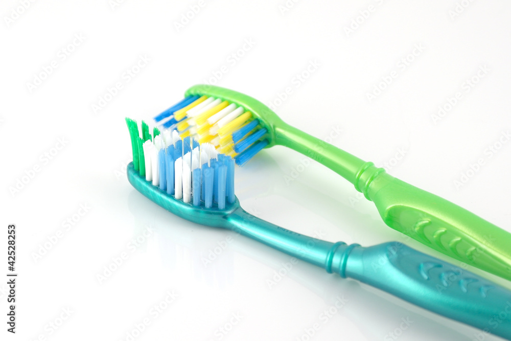 Two tooth-brushes over white Two tooth-brushes over white