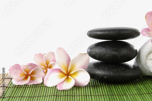 zen stone and frangipani flower showing spa or wellness concept