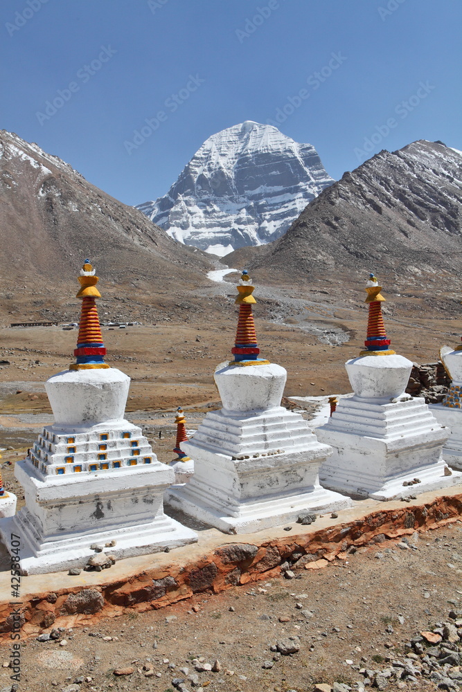 Buddhist statues in Tibet with holy Mount Kailash background