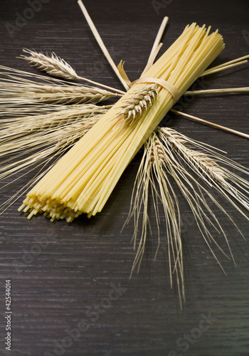 Pasta, spaghetti and corn ears on teak wood photo