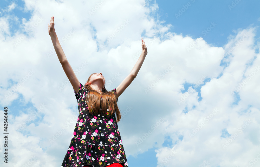 Teen girl with raised hands