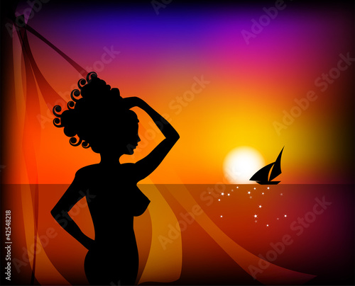 woman watching the horizon at sunset in summer