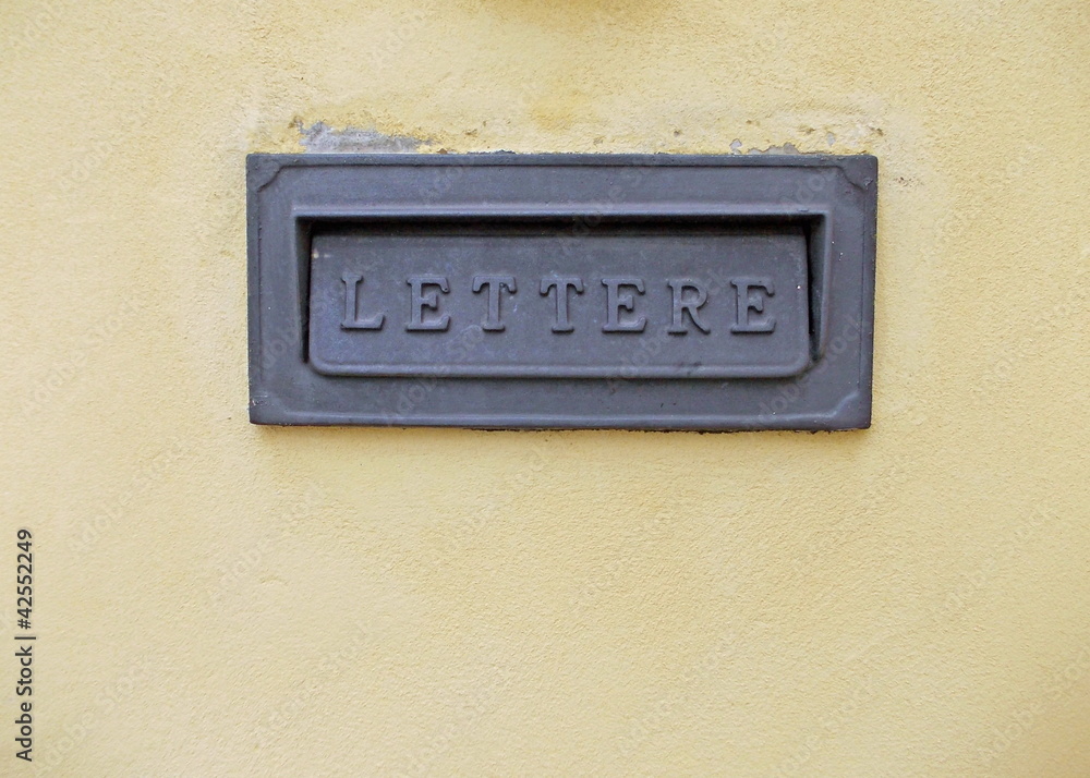 mailbox on a yellow wall in Italy