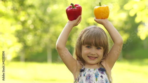 Portrait of a girl holding the hands of vegetables