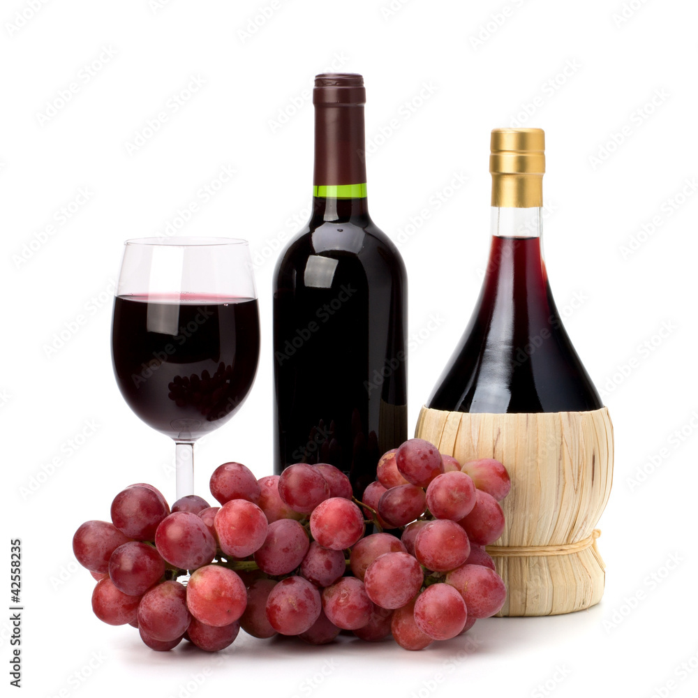 Full red wine glass goblet, bottle and grapes
