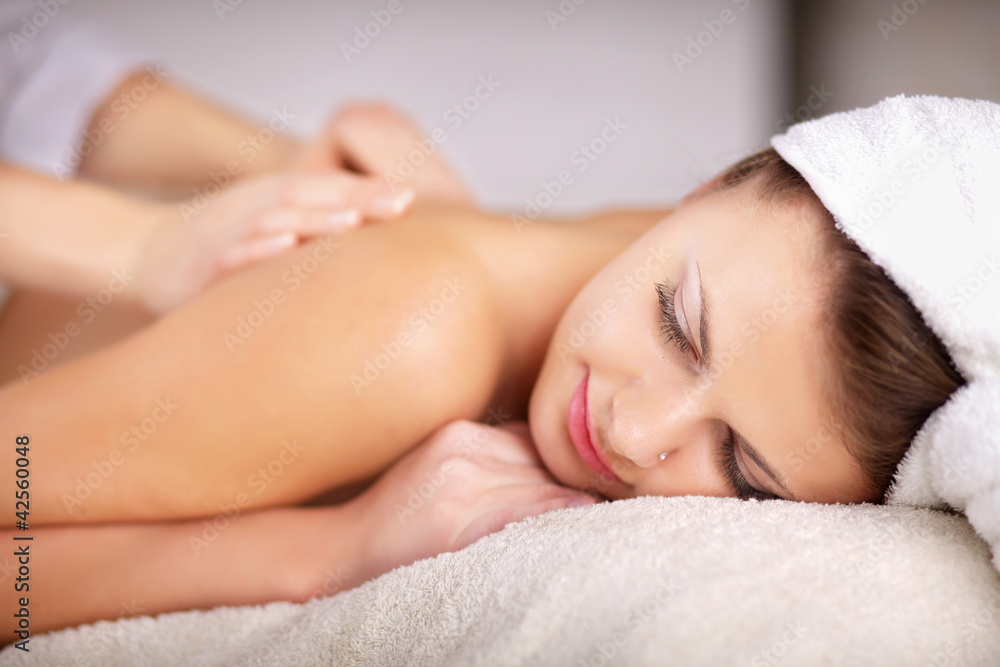 Relaxing massage for young beautiful woman in the spa salon