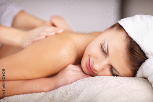 Relaxing massage for young beautiful woman in the spa salon